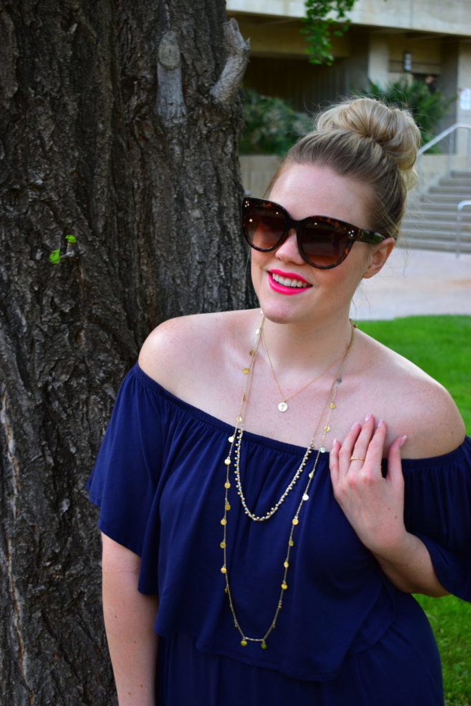 Layered gold jewelry and oversized sunnies
