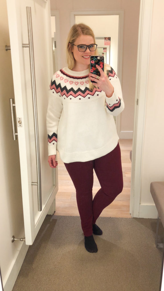 LOFT Winter Collection Try-On wearing a knit heart sweater and cranberry pants 